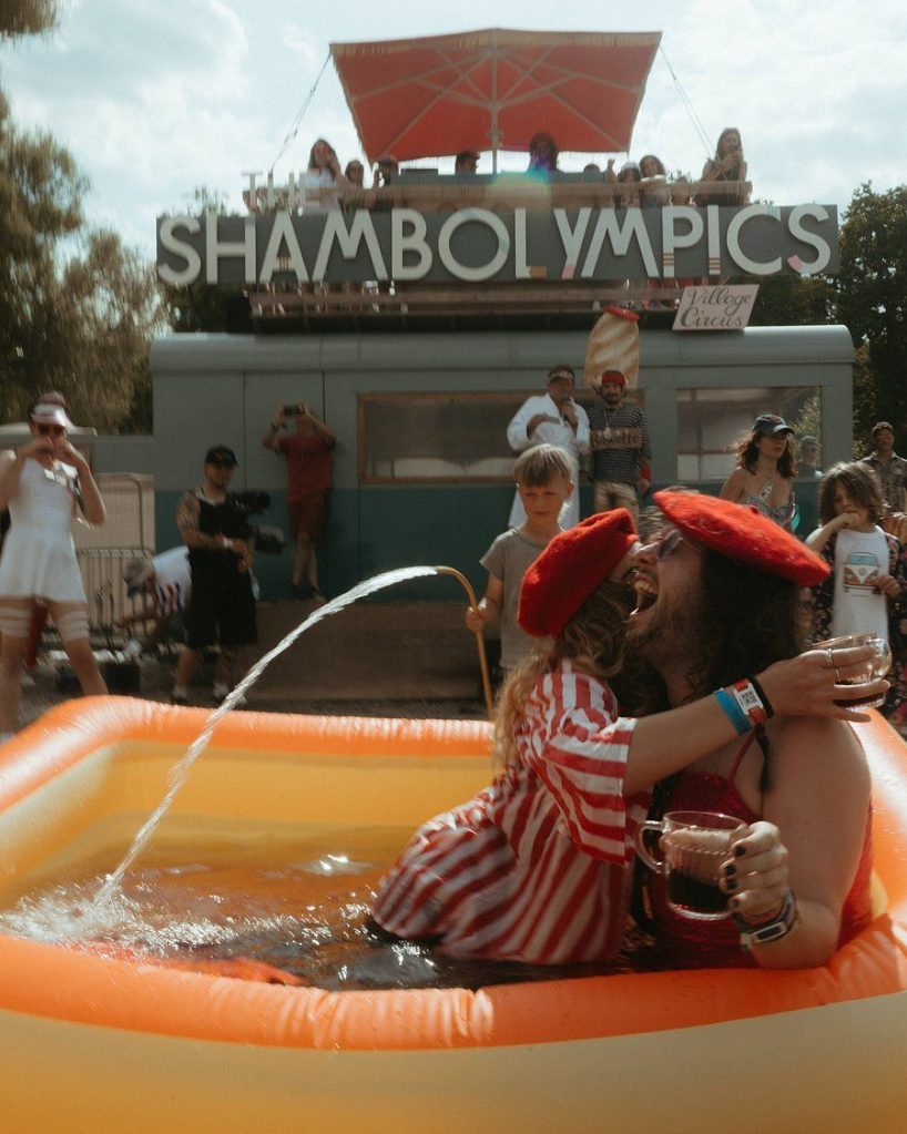 A contestant flips into a paddling pool at the ShambOlympics