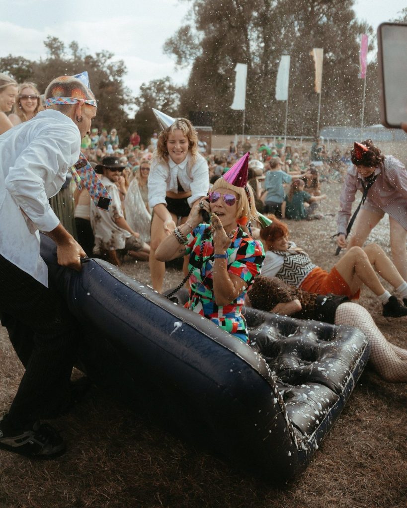 An airbed race through the crowd at the ShambOlympics