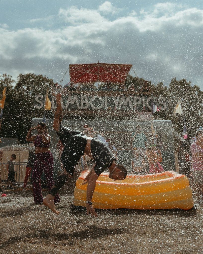 Contestants in a paddling pool in front of the ShambOlympics stage